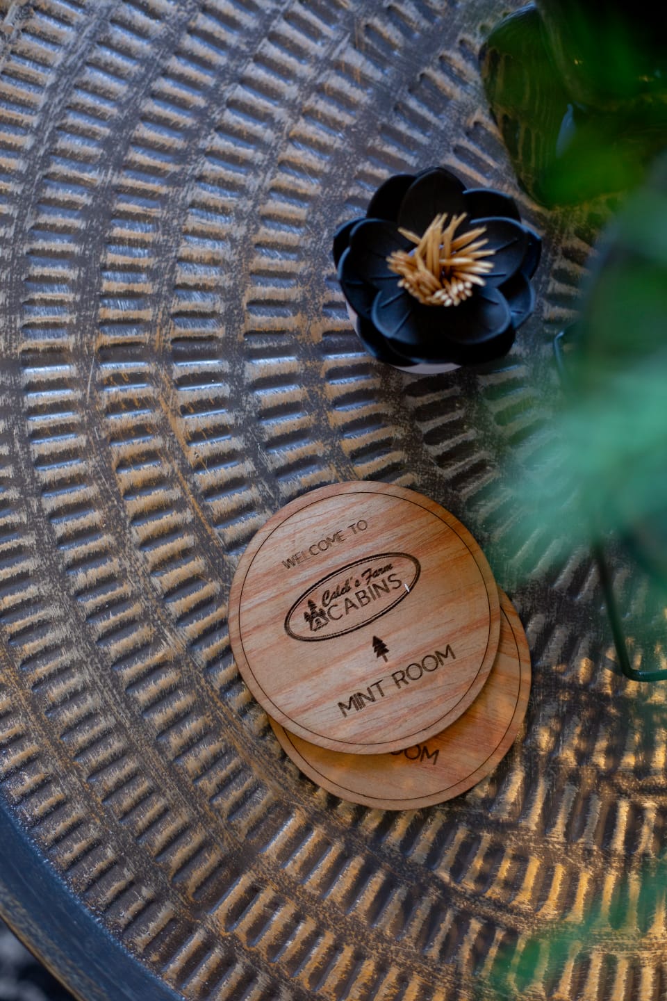 Close-up details from the Mint Room, showing branded wooden coasters and carefully styled decor.